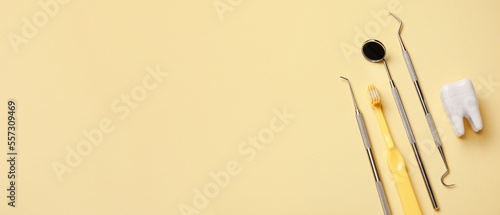 Картината върху платно Brush, plastic tooth and dental tools on beige background with space for text