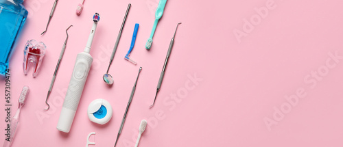 Foto Brushes, floss and dental tools on pink background with space for text