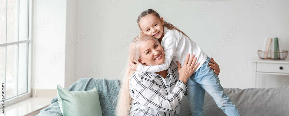 Fototapeta premium Little girl and grandmother hugging at home