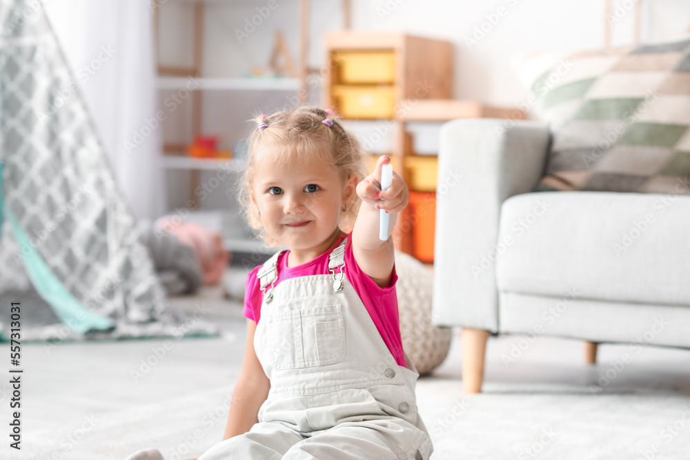 Cute little girl with felt-tip pens sitting on floor at home Cute little girl with felt-tip pens sitting on floor at home