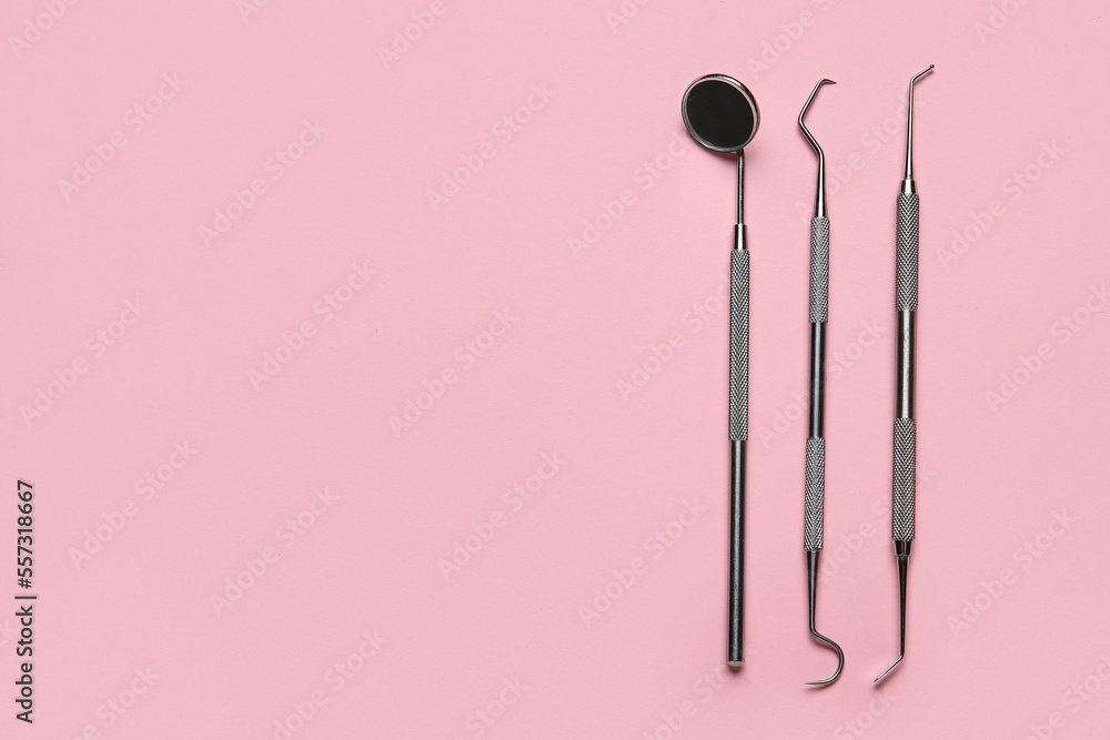 Dental tools on pink background Dental tools on pink background