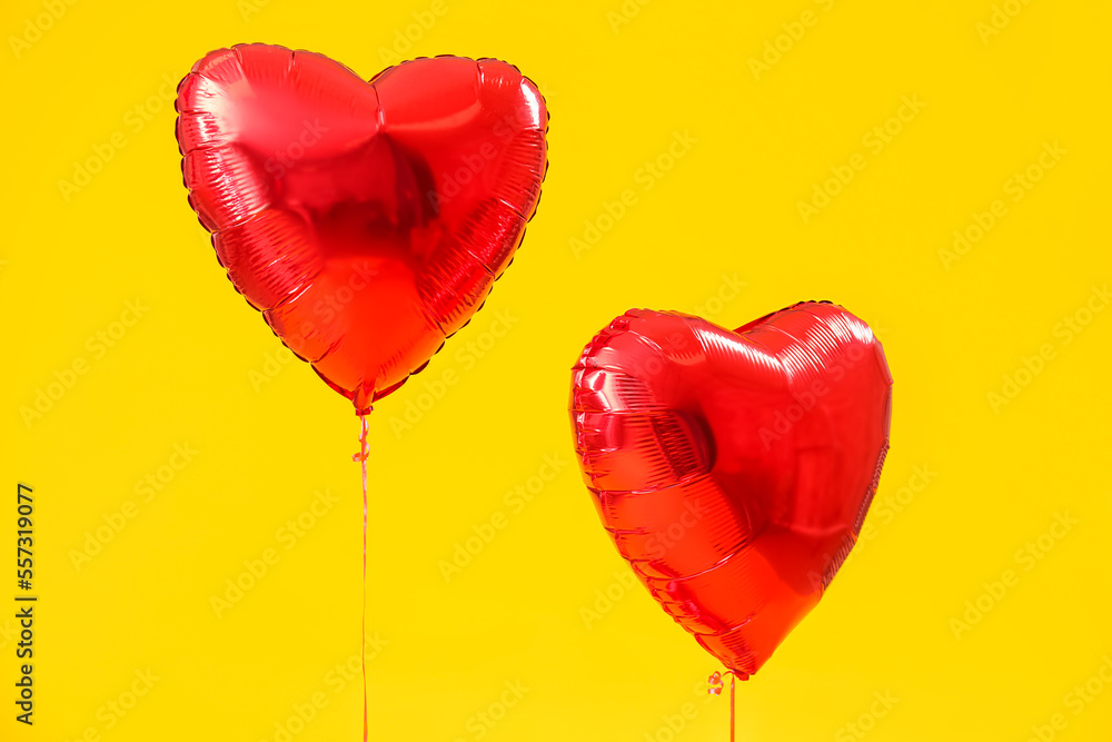 Heart-shaped balloons for Valentine's Day on yellow background Heart-shaped balloons for Valentine's Day on yellow background