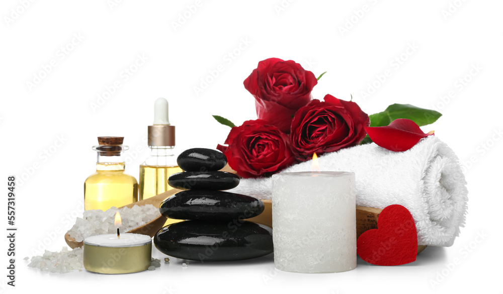 Spa composition for Valentine's Day with stones, candles and roses on white background Spa composition for Valentine's Day with stones, candles and roses on white background