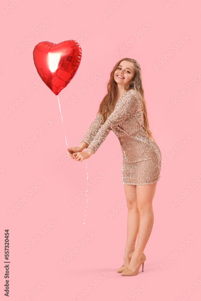 Happy young woman with heart-shaped balloon on pink background. Valentine's Day celebration Happy young woman with heart-shaped balloon on pink background. Valentine's Day celebration