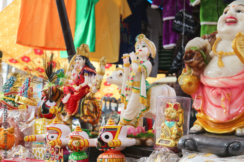 Statue of Krishna, Jagannath and other souvenirs in a shop in Puri, Odisha, India.