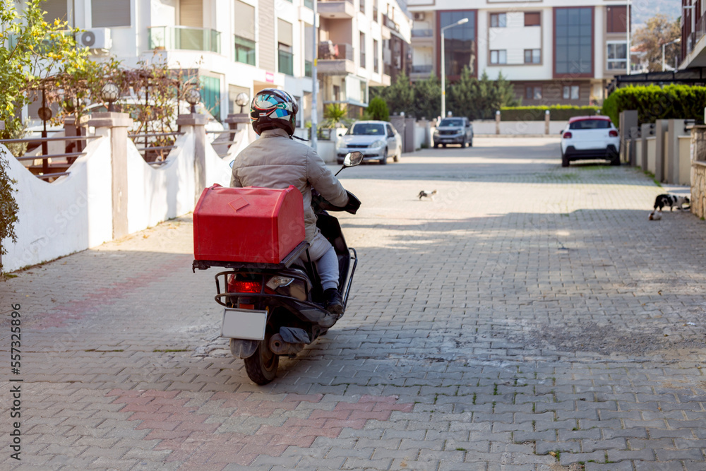 Fast food delivery motorbike man with red bag on the road 