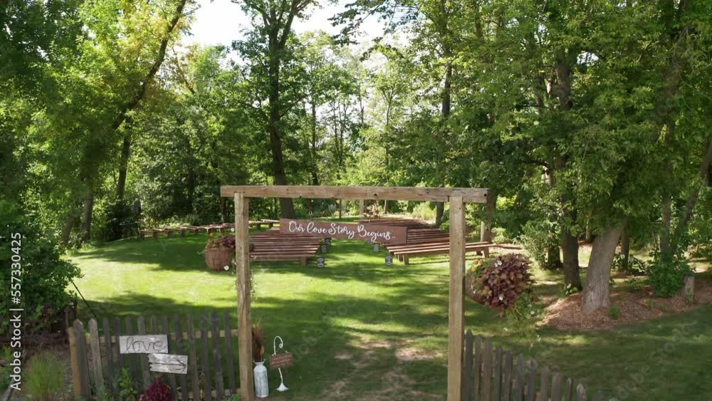 Aerial, empty outdoor forest wedding ceremony venue during a summer day Aerial, empty outdoor forest wedding ceremony venue during a summer day
