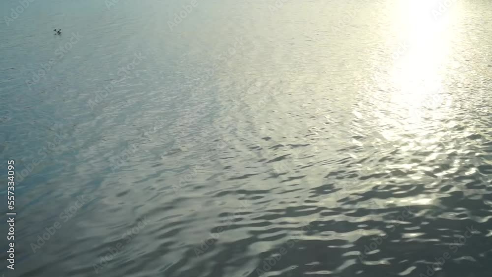 Water waves close up at sunset, Golden rays of sun reflected on surface of water. Water waves close up at sunset, Golden rays of sun reflected on surface of water.