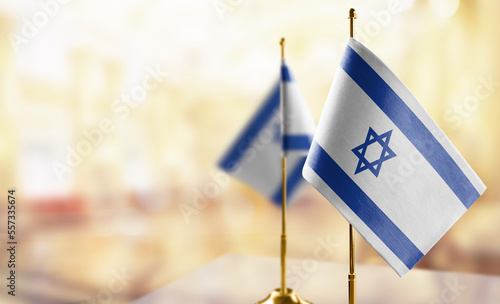 Small flags of the Israel on an abstract blurry background