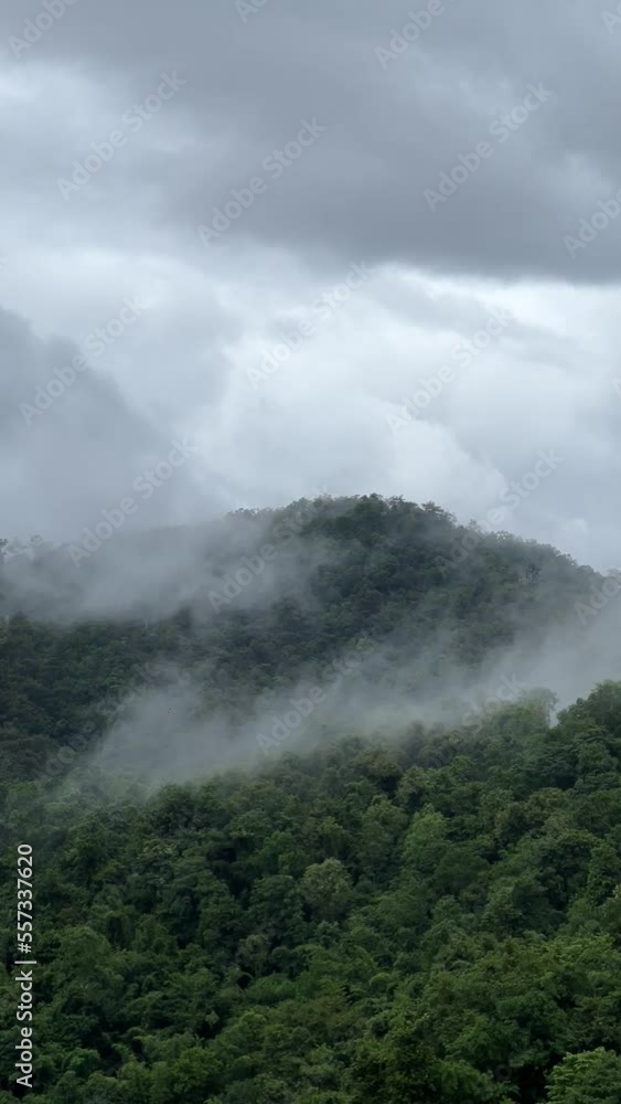 View lush green tropical rain forest mountain with rain cloud cover during the rainy season on the Doi Phuka Mountain reserve national park. In, the northern Thailand.v View lush green tropical rain forest mountain with rain cloud cover during the rainy season on the Doi Phuka Mountain reserve national park. In, the northern Thailand.v