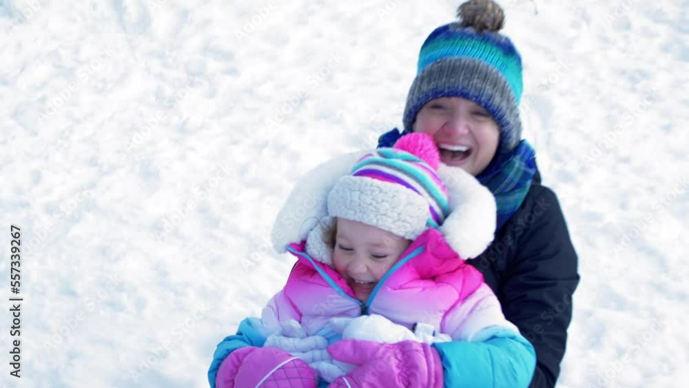 Mother and Daughter Sledding in winter Snow Mother and Daughter Sledding in winter Snow