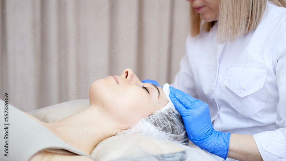 The cosmetologist dries the client's face in the beauty spa salon. The cosmetologist dries the client's face in the beauty spa salon.