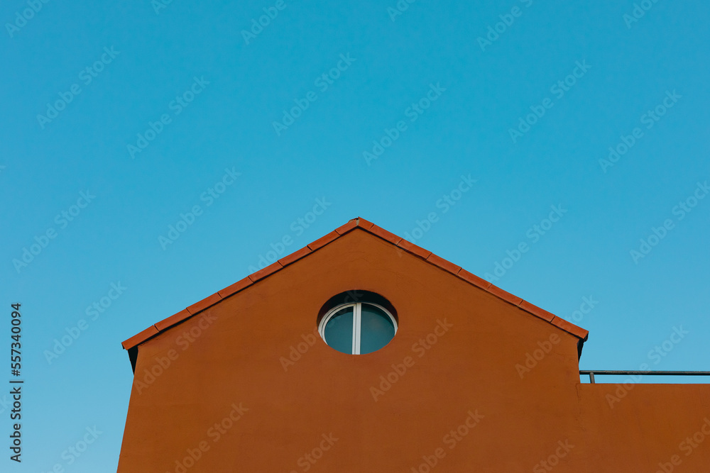Obraz premium orange house roof with blue sky background