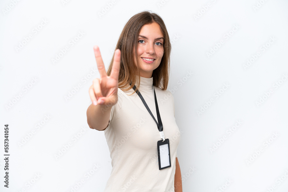 Young pretty woman with ID card isolated on white background smiling and showing victory sign Young pretty woman with ID card isolated on white background smiling and showing victory sign