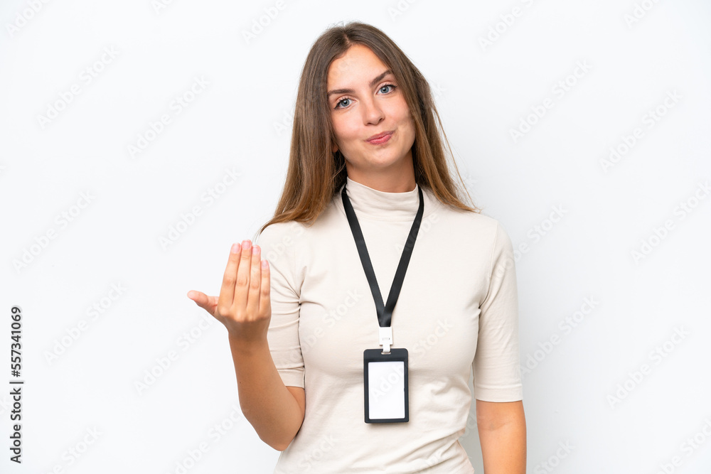 Young pretty woman with ID card isolated on white background inviting to come with hand. Happy that you came Young pretty woman with ID card isolated on white background inviting to come with hand. Happy that you came