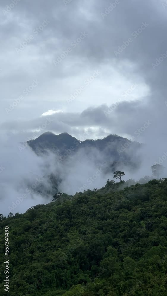 View lush green tropical rain forest mountain with rain cloud cover during the rainy season on the Doi Phuka Mountain reserve national park. In, the northern Thailand.v View lush green tropical rain forest mountain with rain cloud cover during the rainy season on the Doi Phuka Mountain reserve national park. In, the northern Thailand.v