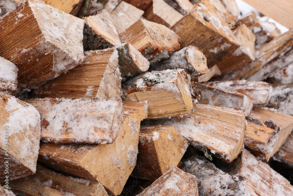 Natural wooden background - closeup of chopped firewood. Firewood prepared for winter Pile of wood logs. Chopped wood for fireplace heating, alternative to gas and electricity. Natural wooden background - closeup of chopped firewood. Firewood prepared for winter Pile of wood logs. Chopped wood for fireplace heating, alternative to gas and electricity.