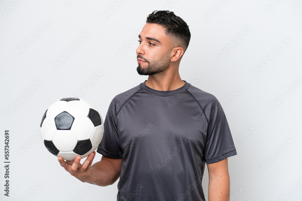 Arab young football player man isolated on white background looking to the side Arab young football player man isolated on white background looking to the side