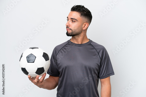 Arab young football player man isolated on white background looking to the side