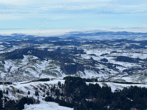 Winter panorama from the top of the Kronberg mountain with a view of the Swiss hills and pastures covered with the first snow, Urnäsch (Urnaesch or Urnasch) - Canton of Appenzell, Switzerland (Schweiz