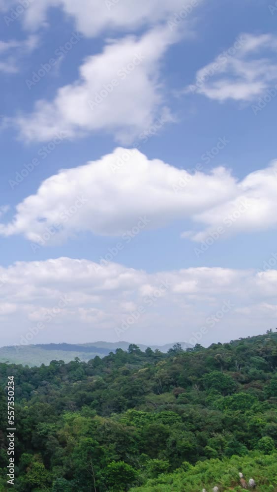 vertical timelapse view of natural winter mountain range with some cloud fog.Flores tropical paradise. Mountain Range under clear blue sky, Aerial View. vertical timelapse view of natural winter mountain range with some cloud fog.Flores tropical paradise. Mountain Range under clear blue sky, Aerial View.