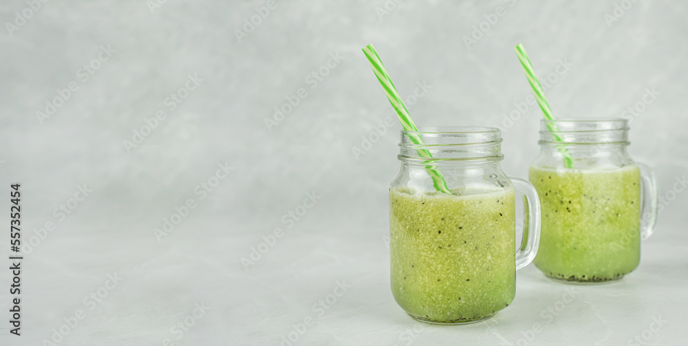 Healthy green smoothie on a light background. Detox drinks made of avocado, kiwi, apple, celery in stylish glass glasses. Proper nutrition and a healthy lifestyle. Banner, copy space for text Healthy green smoothie on a light background. Detox drinks made of avocado, kiwi, apple, celery in stylish glass glasses. Proper nutrition and a healthy lifestyle. Banner, copy space for text
