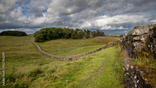 Jolie Photographie de paysage du mur d'Hadrien fuyant dans la campagne anglaise sous un ciel chargé de nuages gris