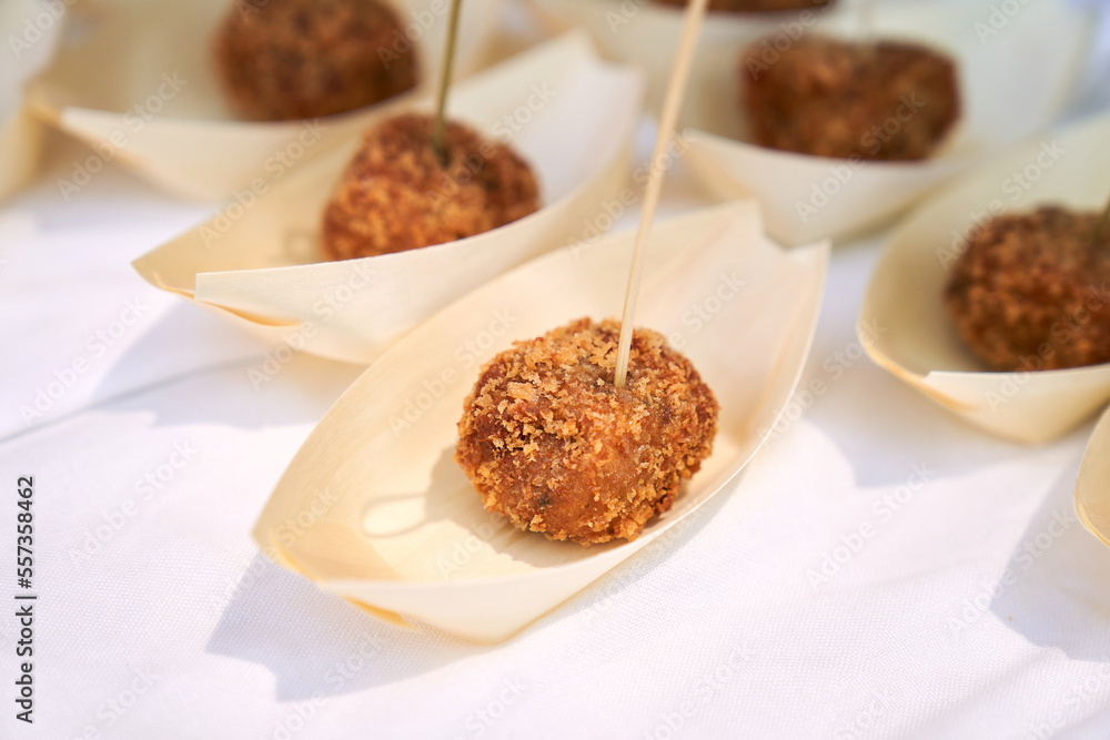 one cocido croquette with a toothpick in single portion one cocido croquette with a toothpick in single portion