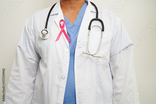 Asian woman doctor with pink ribbon, World Breast Cancer Day at October.