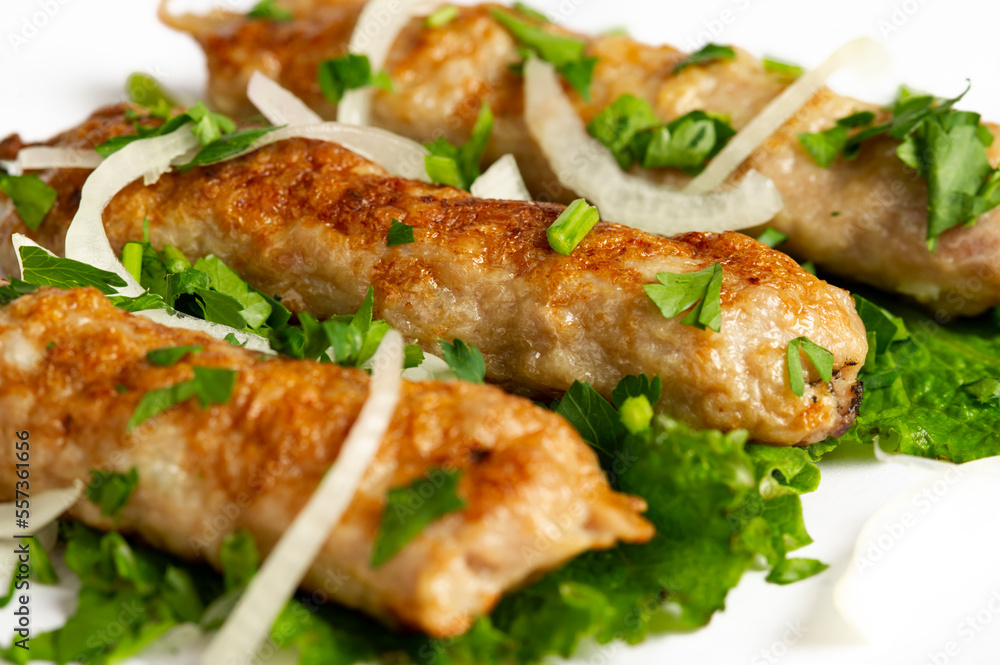closeup of chicken lula kebab on white background closeup of chicken lula kebab on white background