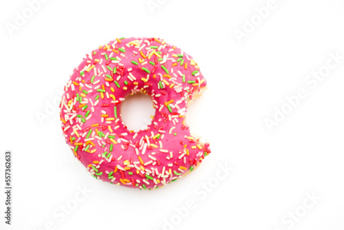 Bitten pink donut isolated on white background