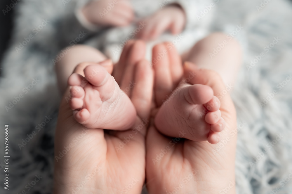 Welcome baby,Mother holding her newborn baby foot, love at first sight, baby feels love and security from mother, pro life Welcome baby,Mother holding her newborn baby foot, love at first sight, baby feels love and security from mother, pro life