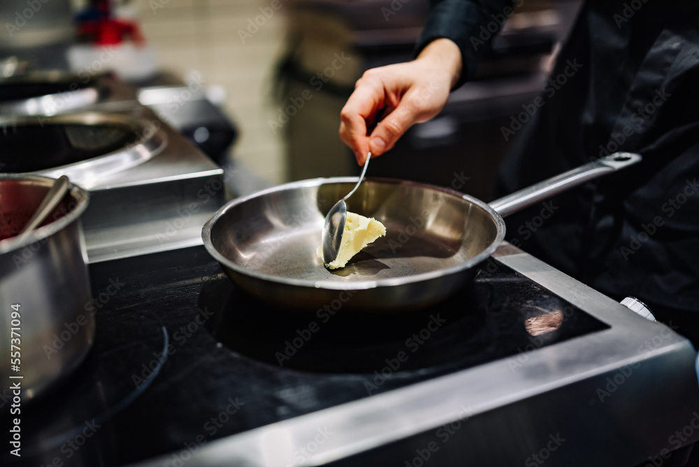 chef frying butter in pan at kitchen chef frying butter in pan at kitchen