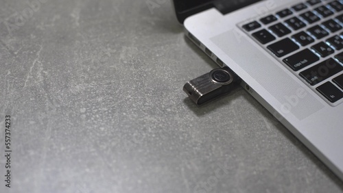 Connect a usb flash drive key to the port of a laptop pc computer.
