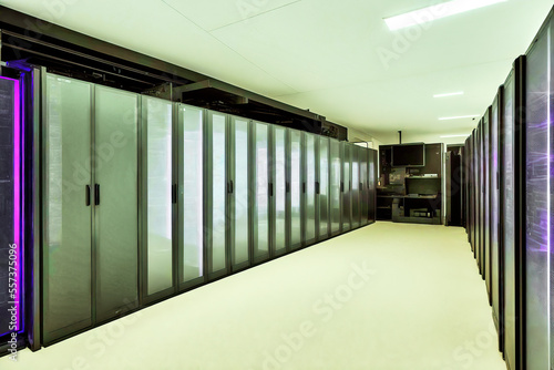 Empty scary room with rows of monotonous similar tall wall cabinets, at the vanishing point of which is an office workplace, made with generative AI