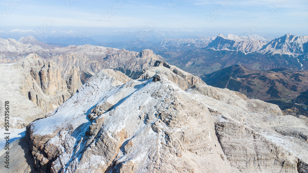 The iconic summit of Piz Boè in the Dolomites with hikers and climbers on a stunning autumn day