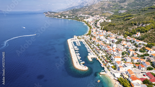 Panorama of Baska Voda town with harbor against mountains in Makarska riviera, Dalmatia, Croatia