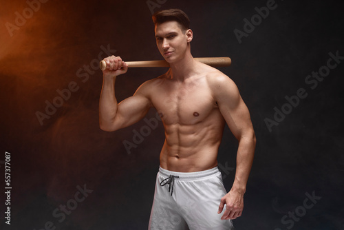 Photography Waist up portrait view of muscle man posing in studio with baseball bat