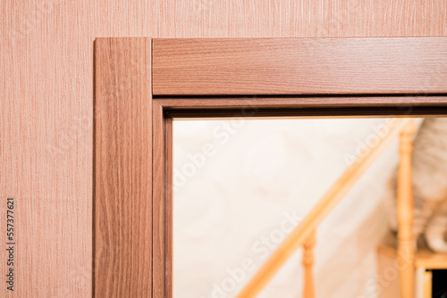 Door frame with an architrave of a brand new installed door into the bedroom  with wooden staircase. Design. Style. Interior. Housing