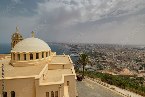 Panorama view of blessed virgin mary church from Santa Cruz fortress, one of the three forts in Oran, the second largest port of Algeria; Summer day, looking from high above towards the city. photo