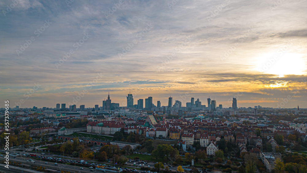 Warsaw at sunset. The capital of Poland is illuminated by a beautiful orange sun. Panorama of Old Town and downtown