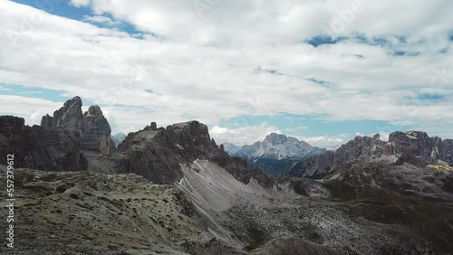 An endless view on a high desolated mountain peaks in Italian Dolomites, South Tyrol (Alto Adige), Italy, Europe. Idyllic hiking trail to Oberbachernspitz. Raw unspoiled landscape. Cloud covered sky