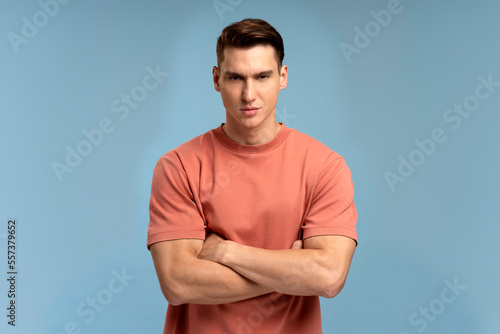 Portrait of attentive self confident man looking at camera with serious expression