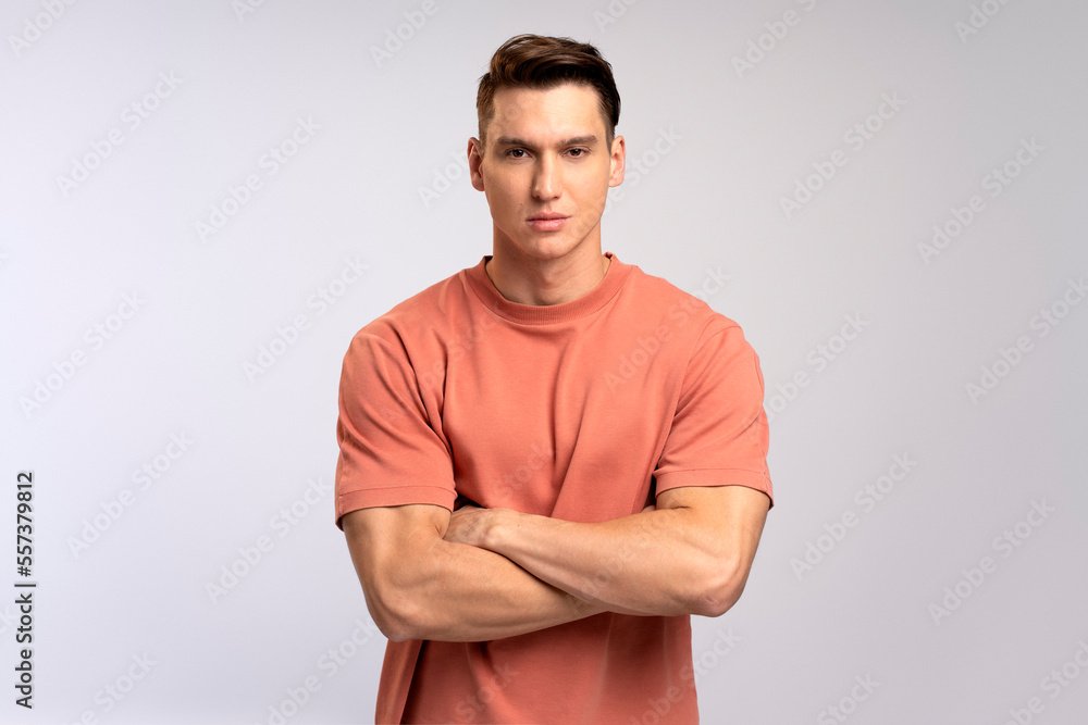 Fototapeta premium Portrait of attentive self confident man looking at camera with serious expression