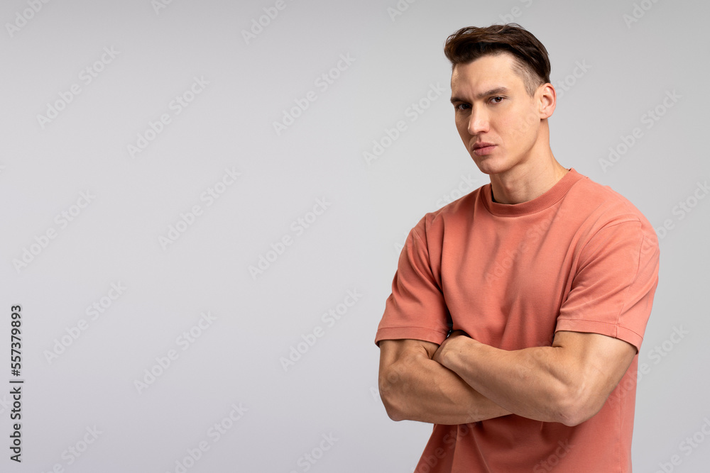 Fototapeta premium Portrait of attentive self confident man looking at camera with serious expression