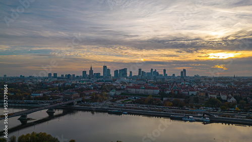 Warsaw at sunset. The capital of Poland is illuminated by a beautiful orange sun. Panorama of Old Town and downtown