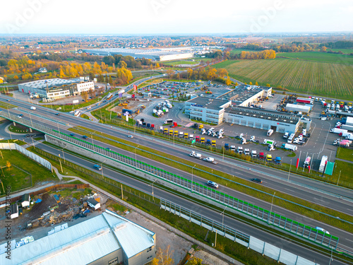 Aerial view of goods warehouse. Logistics center in industrial city zone from above. Aerial view of trucks loading at logistic center © netsay