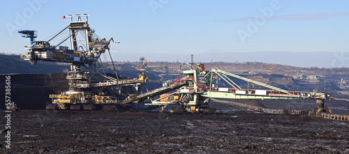 Bucket-wheel excavator during excavation at the surface mine. Huge excavator on open pit mine.