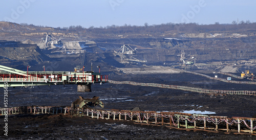Bucket-wheel excavator during excavation at the surface mine. Huge excavator on open pit mine.