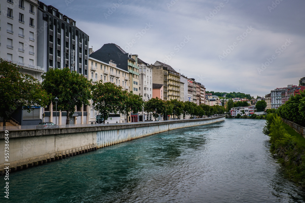 Riverbanks of the Gave de Pau river in the pilgrimage city of Lourdes in the French Pyrenees Riverbanks of the Gave de Pau river in the pilgrimage city of Lourdes in the French Pyrenees